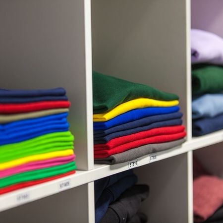 Many different shirts on one shelf